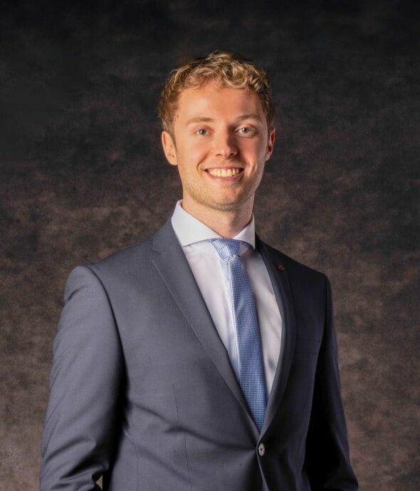 Viktor Wagner, the founder of Hotel Go, smiling in a suit, looks into the camera